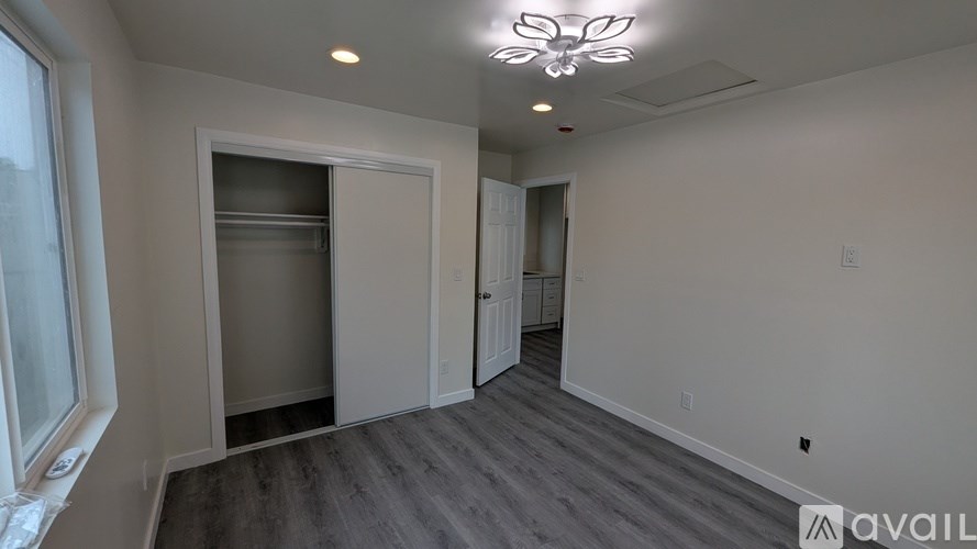 A room with a refrigerator and a window.