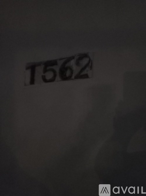 A white sign with black text reading T562 is on a wall.