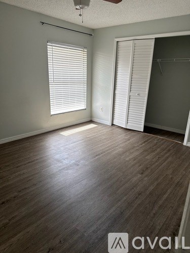 A room with wooden flooring and a sliding door.