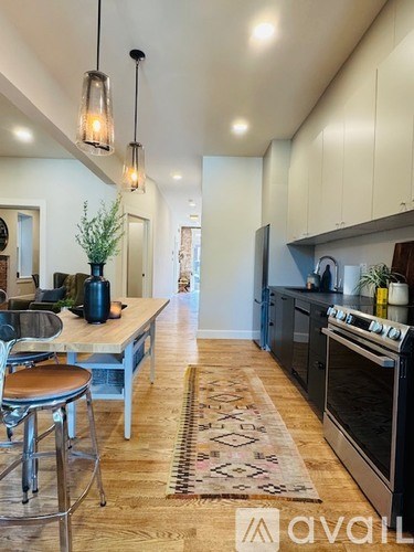 A kitchen with a table and chairs in the middle of the room.