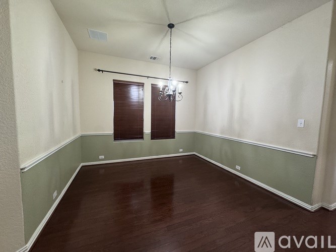 A room with wooden floors and a chandelier.