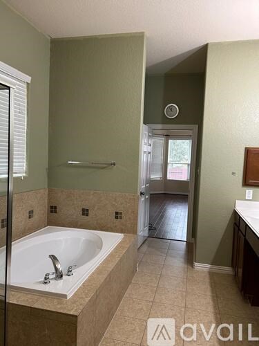 A bathroom with a tub and a shower.