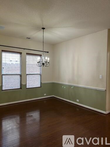 A room with a chandelier and a window.