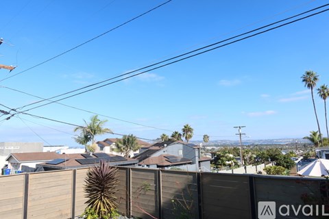 A view of a neighborhood with houses and palm trees.