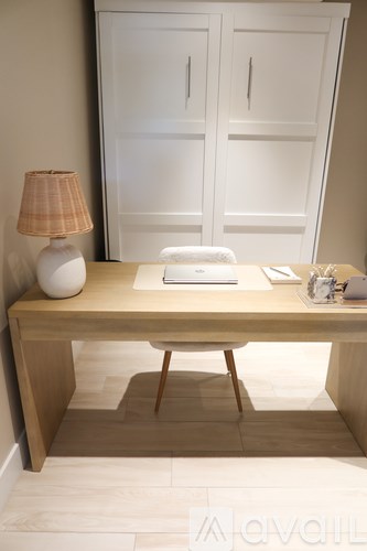 A desk with a lamp and a book on it.