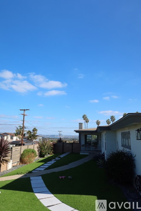 A house with a lawn and a pathway in front of it.