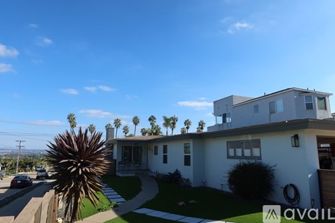 A house with a palm tree in front of it.