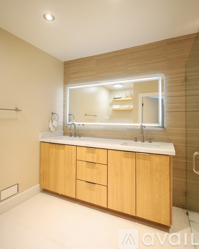 A bathroom with a vanity and a mirror.