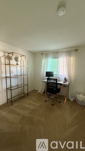 A room with a desk and a chair in it.