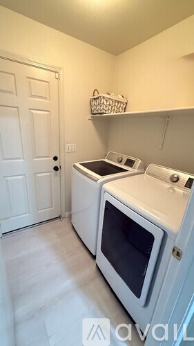 A white microwave oven is placed in a kitchen.