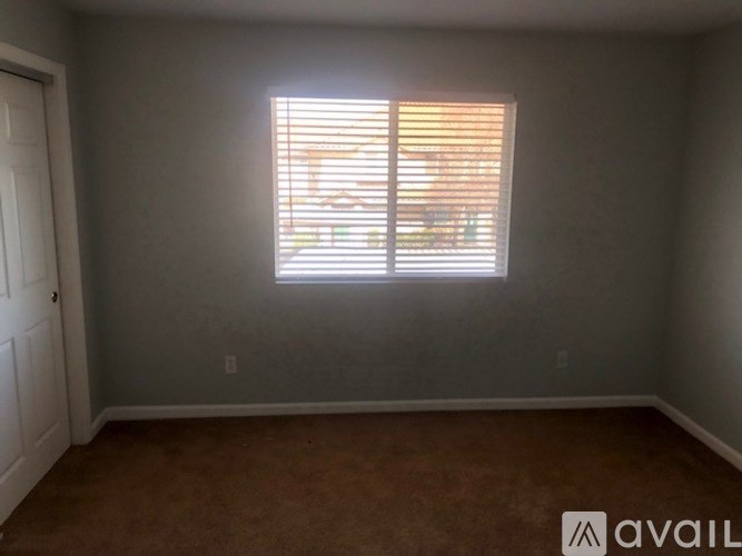 A room with a window and a door.