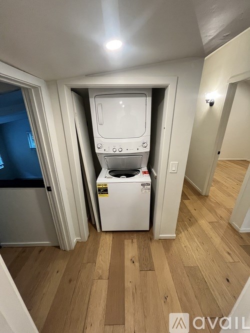 A small laundry room with a washer and dryer.