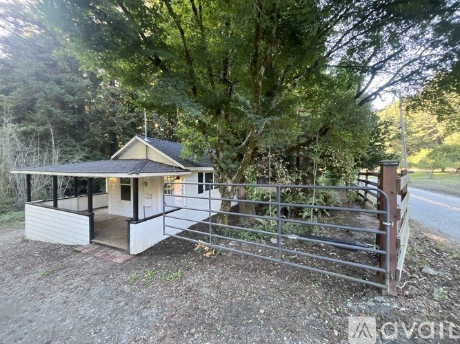 A house with a metal gate in front of it.