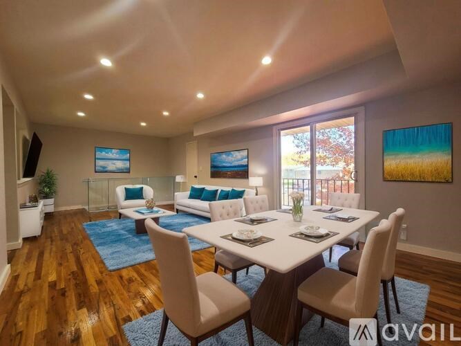A dining room with a white table and chairs.