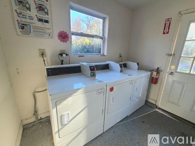 A white washing machine and dryer in a small room.