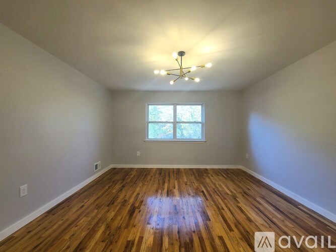 A room with wooden floors and a window.
