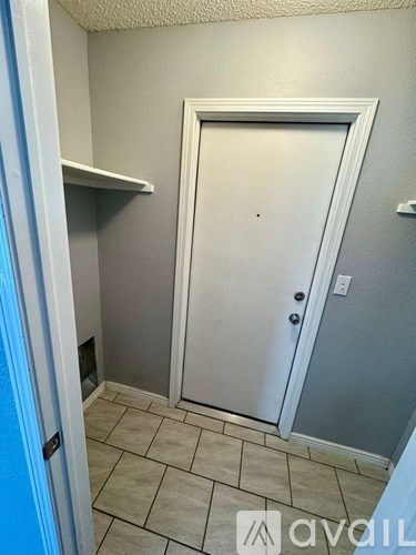 A white door in a room with a tiled floor.