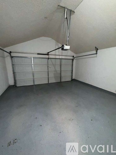 A room with a white ceiling and a grey floor.