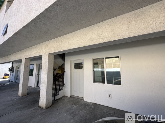 A white door is on the right side of a building.