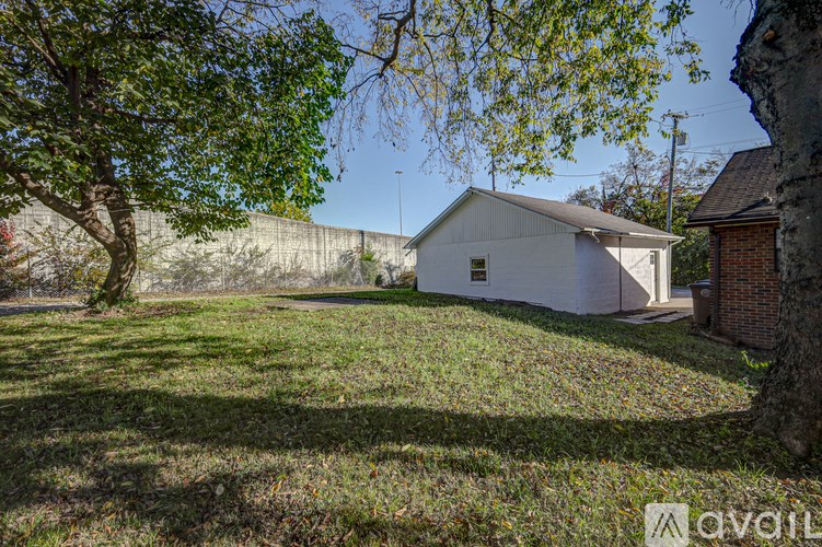 A white house with a tree in front of it.