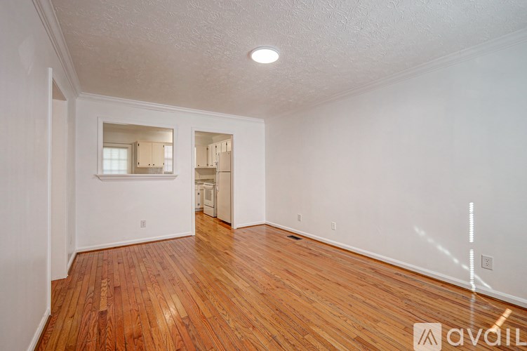 A room with wooden floors and white walls.