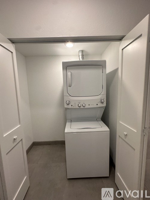 A white bathroom stall with a toilet and a sink.