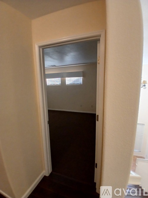 A doorway with a window and blinds.