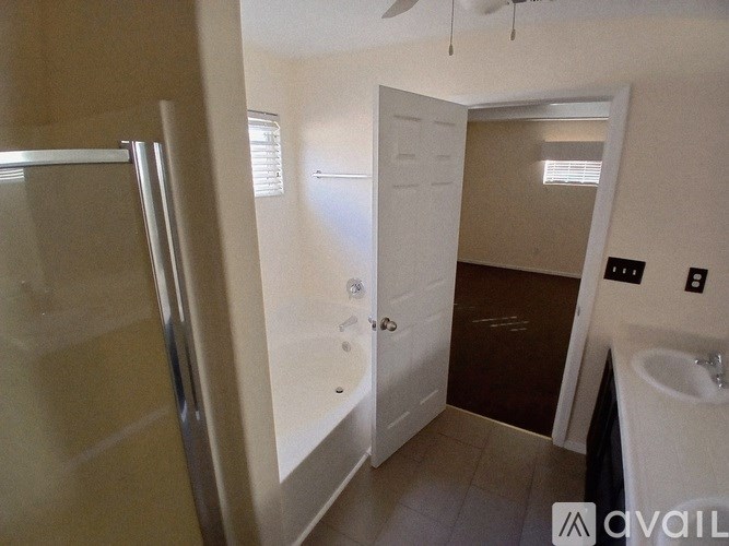 A bathroom with a sink, mirror, and shower.