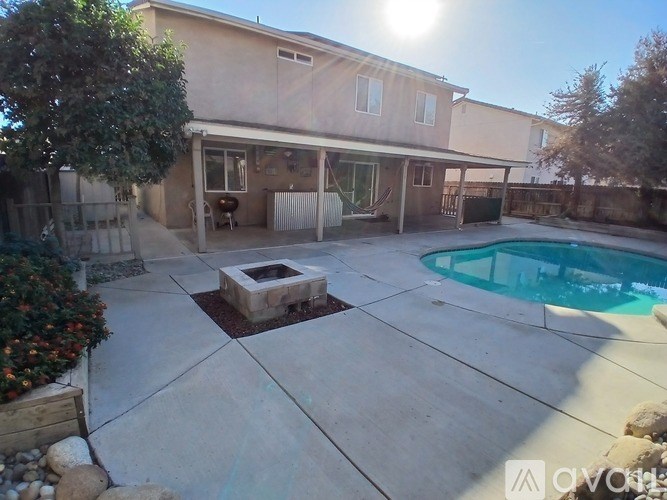 A house with a pool and a patio area.