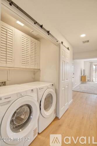 A laundry room with a washer and dryer in it.