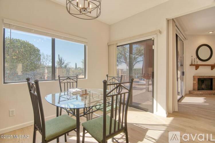 A dining room with a glass table and chairs.