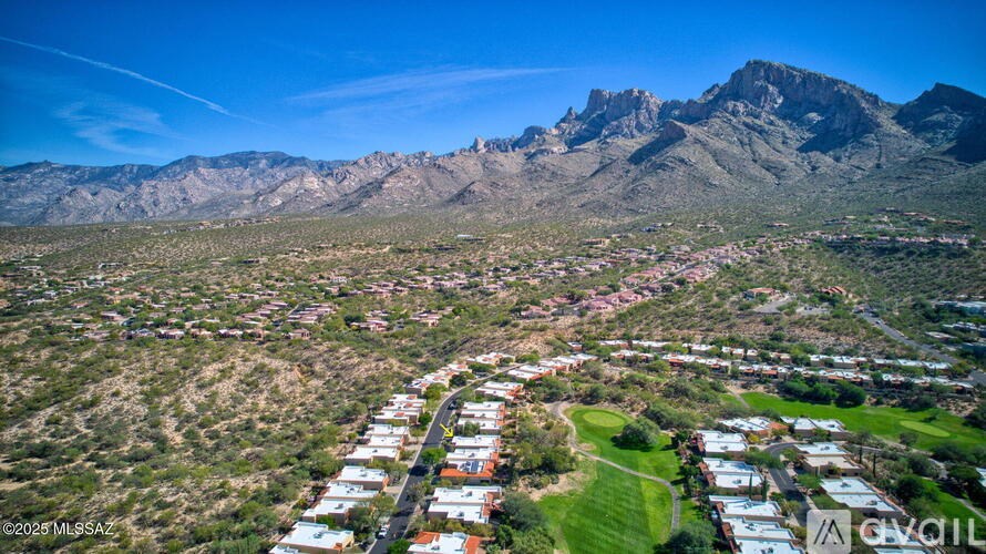 A mountain range looms over a residential area.