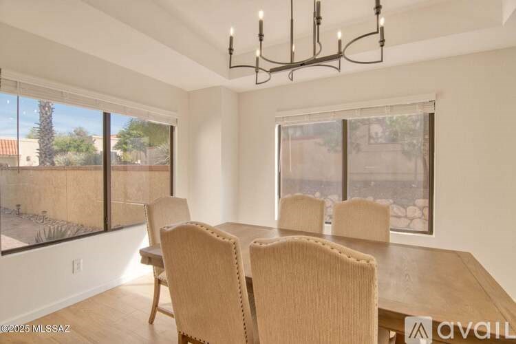A dining room with a wooden table and chairs.