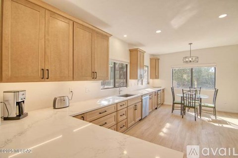 A kitchen with wooden cabinets and a marble countertop.
