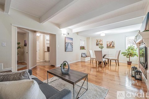 A living room with a grey couch and a coffee table.