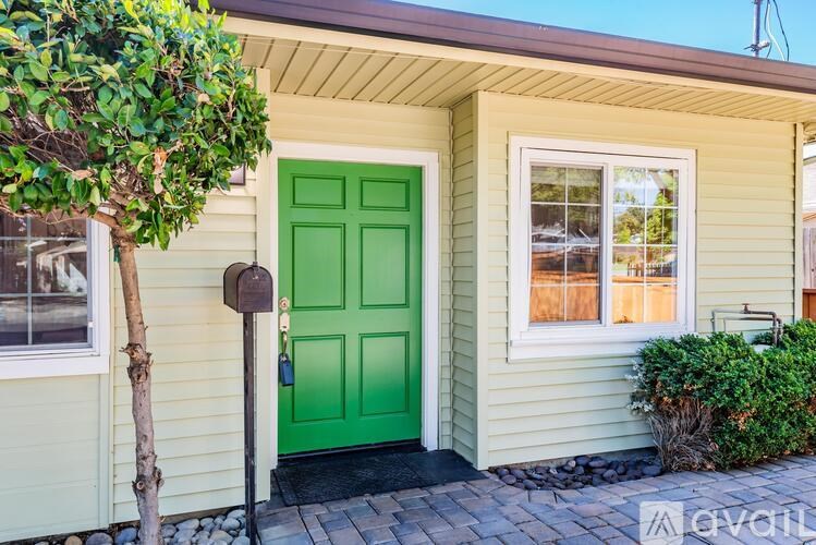 A green door is on the front of a house.