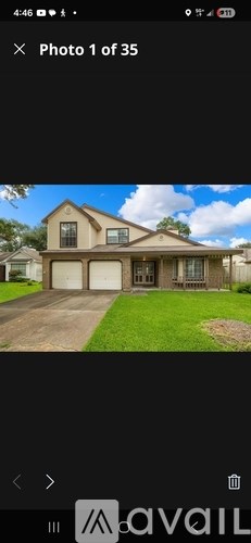 A house with a brown roof and a white garage door.