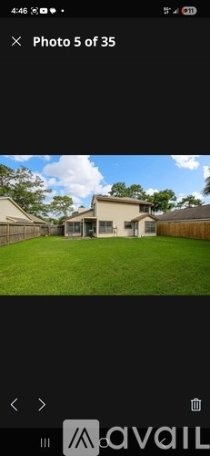 A house with a green lawn in front of it.
