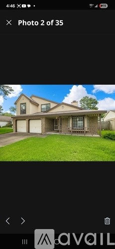A house with a brown roof and a white garage door.
