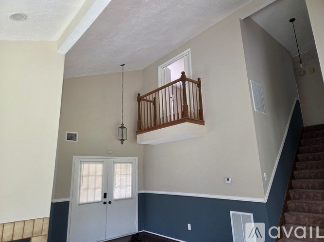 A room with a staircase and a door.