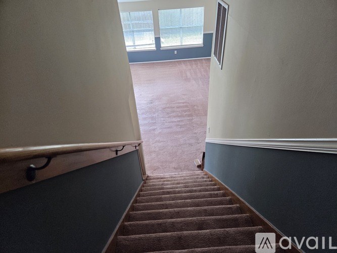 A staircase leading to a room with a window.