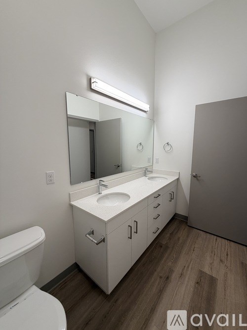 A bathroom with a white sink and a white toilet.