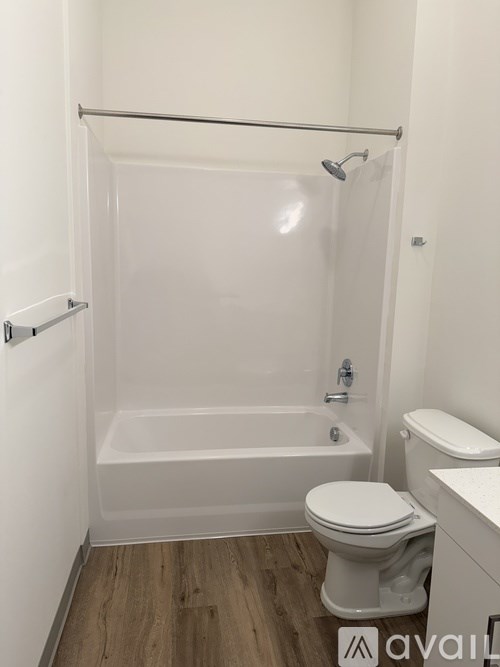 A white bathroom with a toilet, tub, and sink.