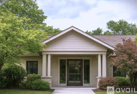 A house with a front porch and a brown roof.