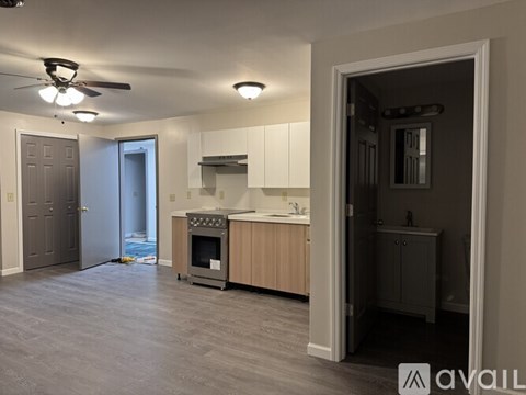 A modern kitchen with a grey floor and white walls.