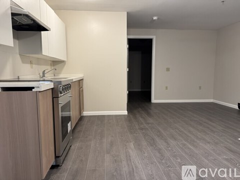 A kitchen with a stove top oven and a sink.