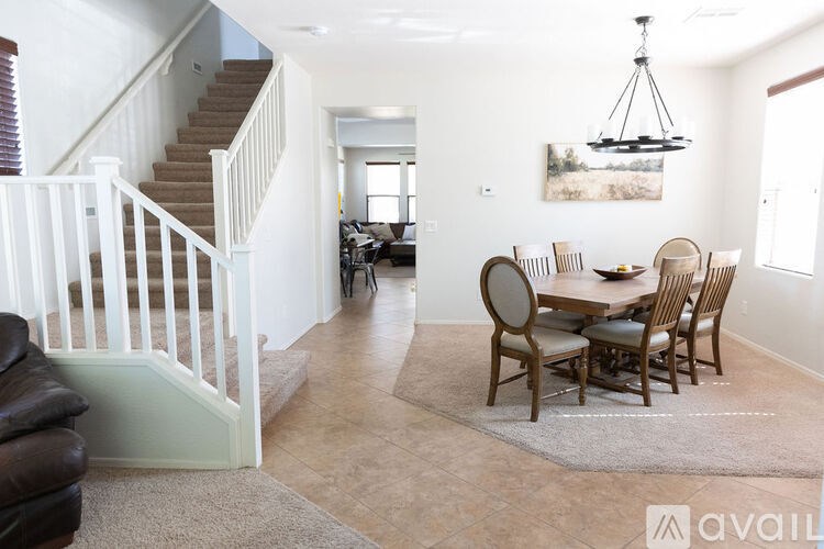 A living room with a dining table and chairs.
