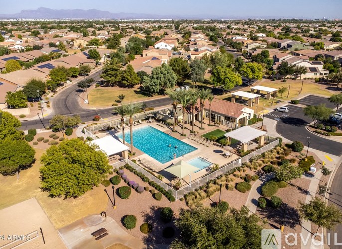 A bird's eye view of a residential area with a swimming pool.