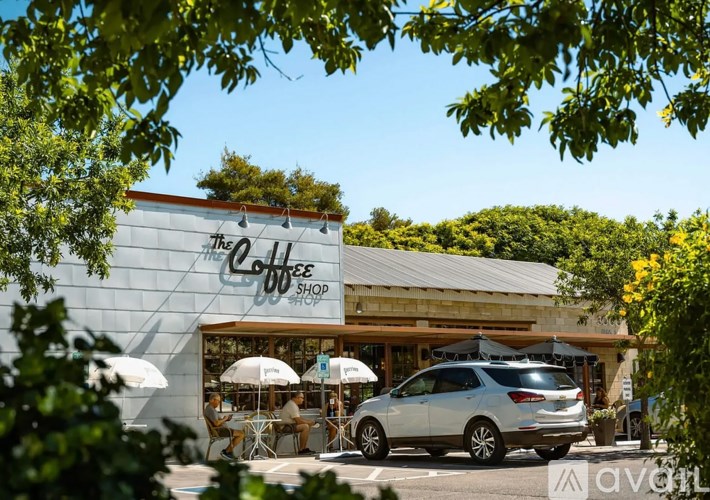A car is parked in front of a coffee shop.