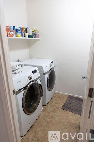 A small laundry room with two front loading washing machines.